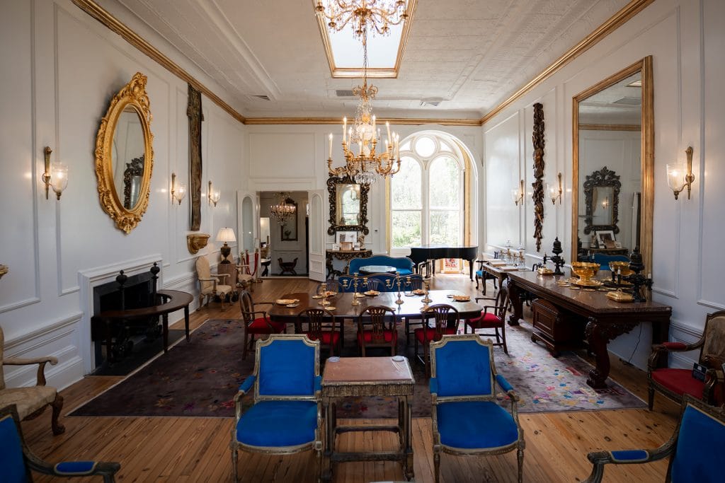 A sophisticated room featuring an elegant table surrounded by stylish chairs, exuding a sense of luxury and comfort at 20 South Battery