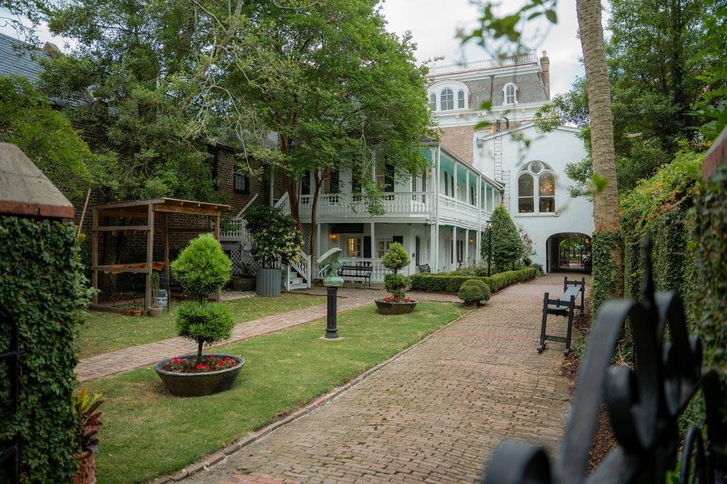 A scenic walkway directs towards 20 South Battery, with a church rising in the background.